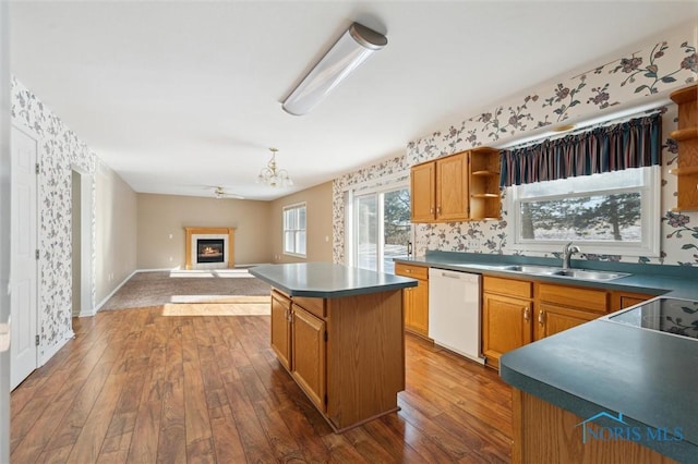 kitchen featuring sink, dishwasher, ceiling fan, hardwood / wood-style flooring, and a kitchen island