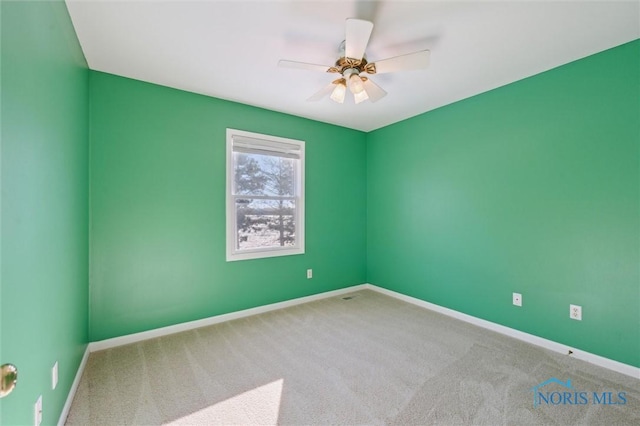 spare room featuring carpet floors and ceiling fan