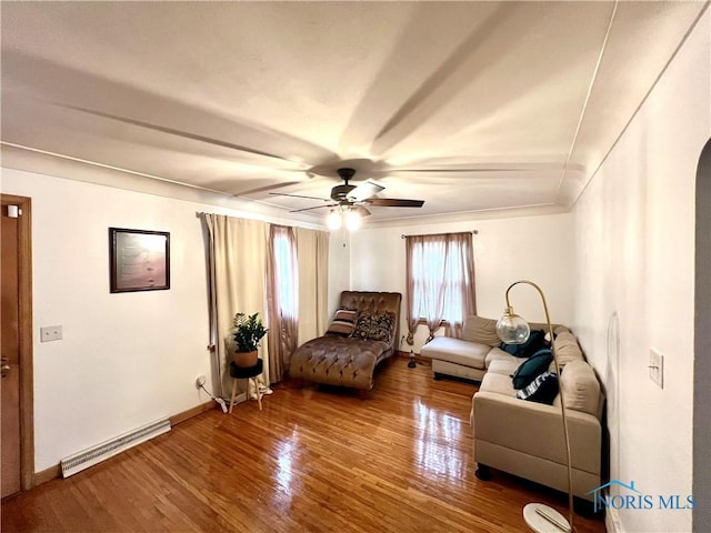 living area featuring wood-type flooring and ceiling fan