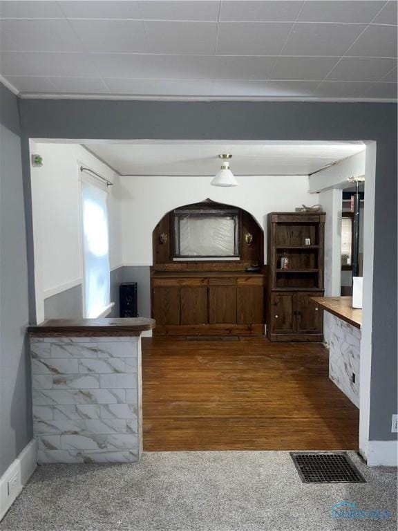 interior space featuring dark colored carpet