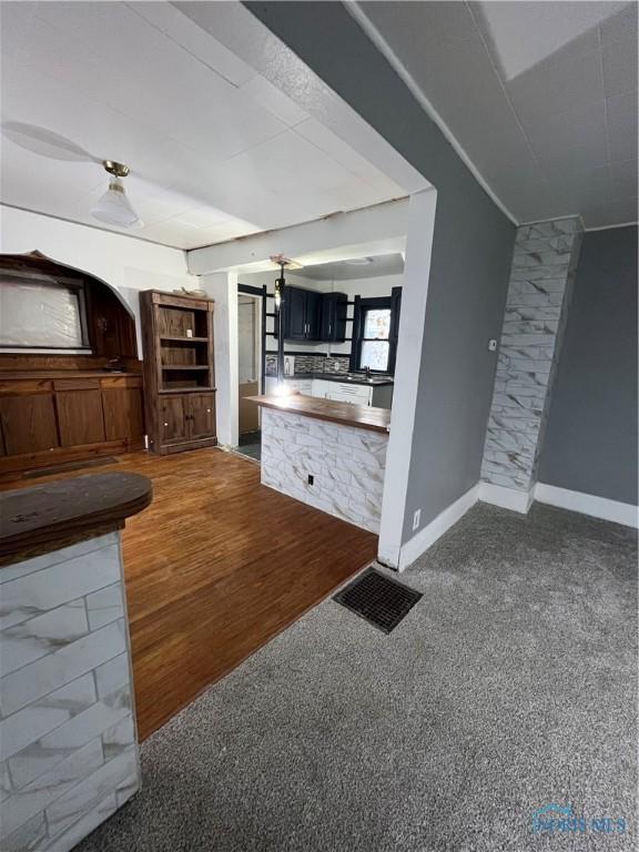 unfurnished living room featuring dark colored carpet