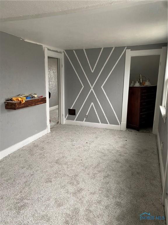 spare room featuring carpet