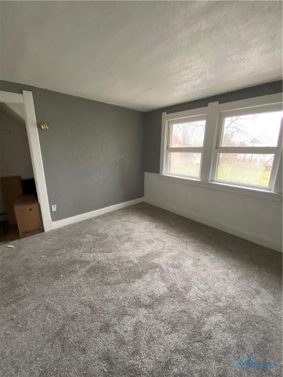 spare room with carpet floors and a textured ceiling