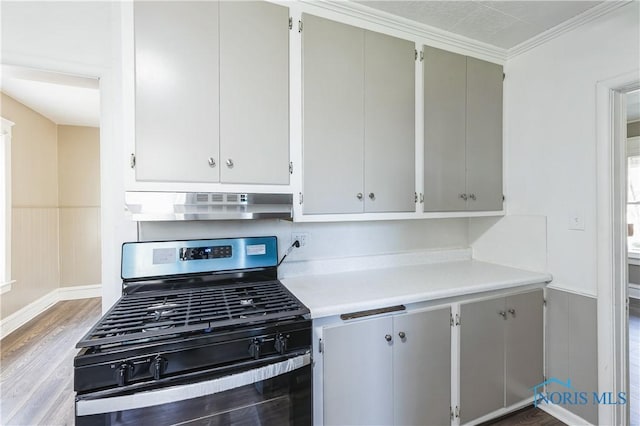 kitchen with gas stove, ventilation hood, hardwood / wood-style flooring, and crown molding