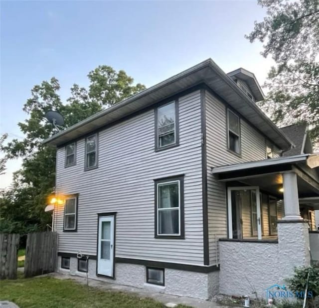 back of house with a lawn