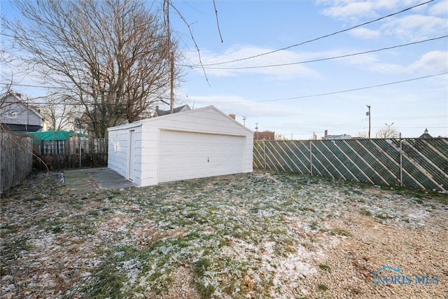 view of yard featuring a garage and an outbuilding