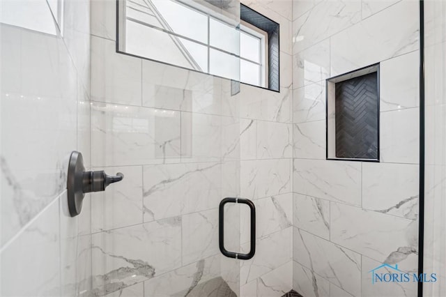 bathroom featuring a shower with shower door