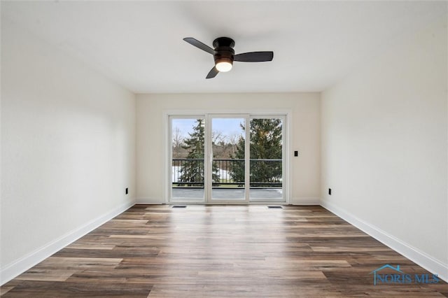 unfurnished room with ceiling fan and dark wood-type flooring