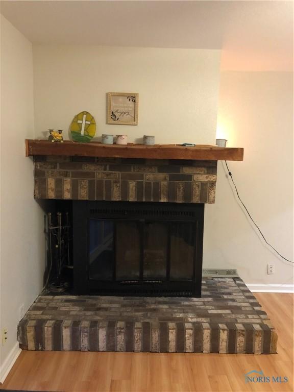 interior details with a fireplace and hardwood / wood-style flooring