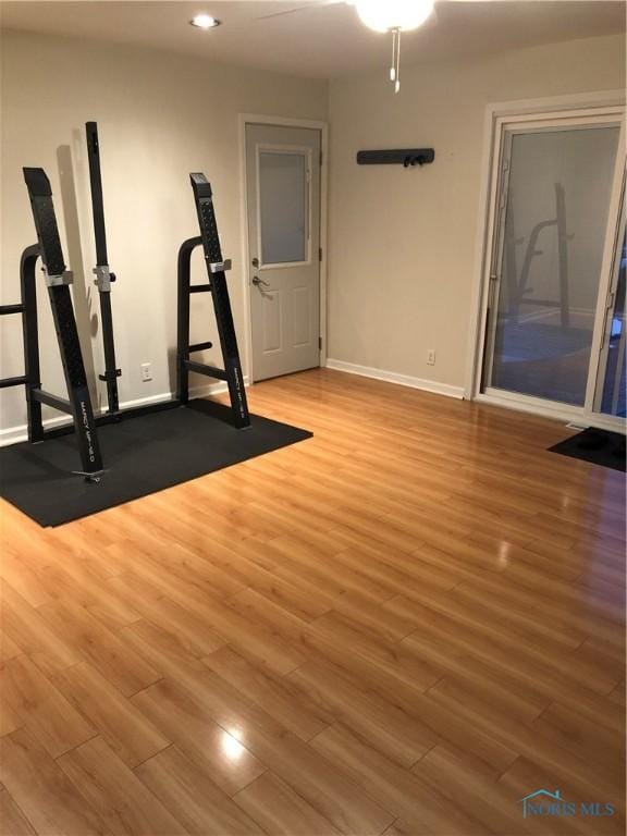 workout room with wood-type flooring