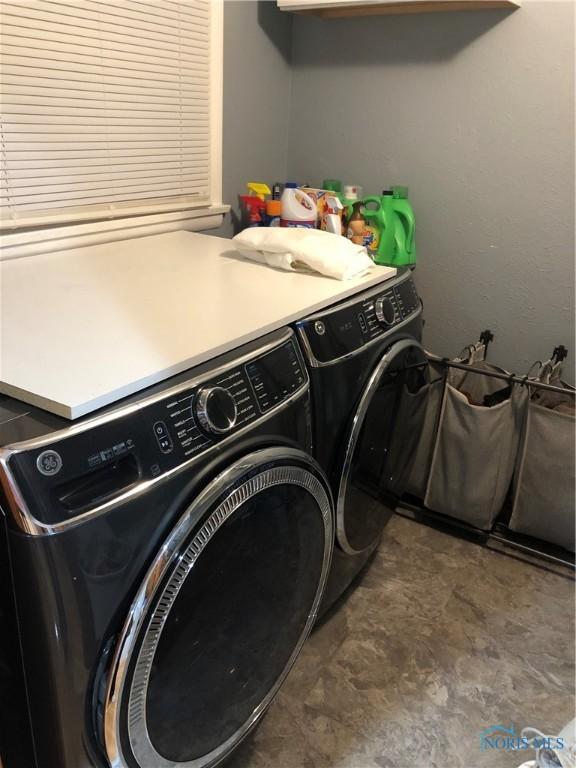 laundry area with independent washer and dryer