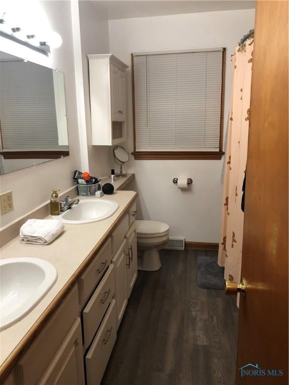 bathroom featuring hardwood / wood-style flooring, vanity, and toilet