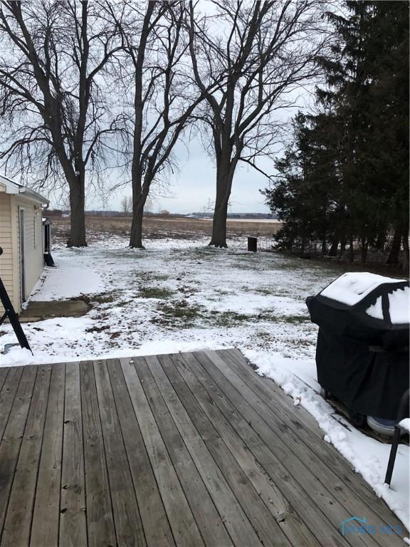 snow covered deck featuring a grill