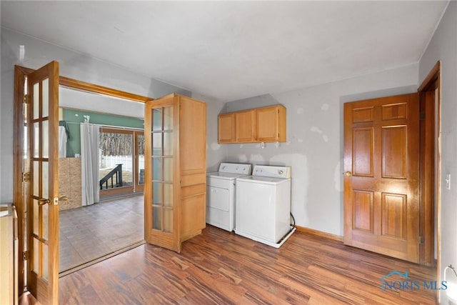 laundry area featuring french doors, cabinets, washer and dryer, and wood-type flooring