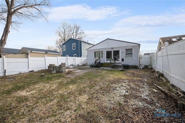 rear view of property with a lawn