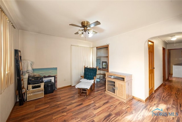 sitting room with ceiling fan and dark hardwood / wood-style flooring