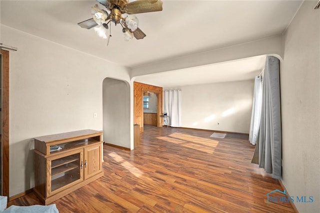 unfurnished room with ceiling fan and dark hardwood / wood-style flooring