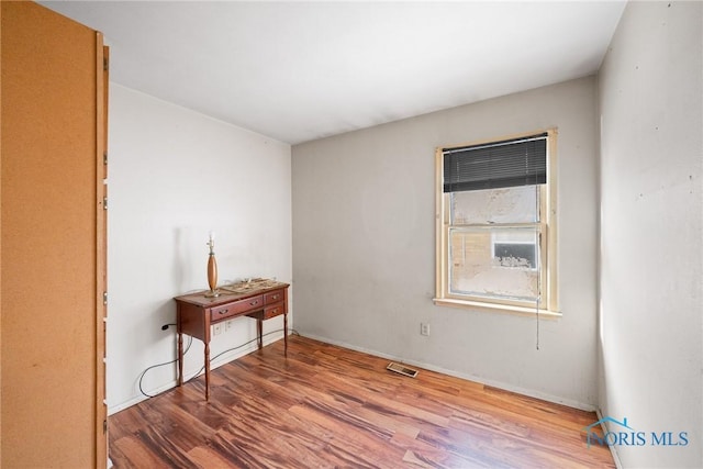 spare room featuring hardwood / wood-style floors