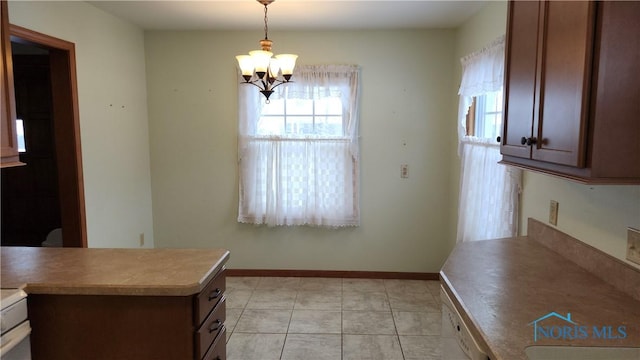 kitchen with a notable chandelier, light tile patterned floors, white dishwasher, and decorative light fixtures