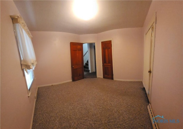 unfurnished bedroom featuring carpet floors and a closet