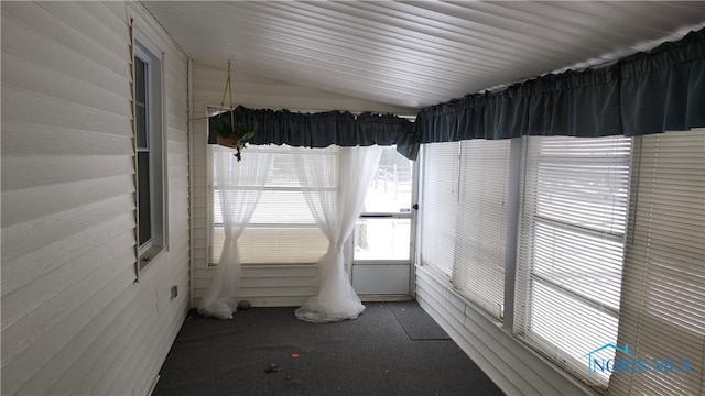 unfurnished sunroom featuring lofted ceiling