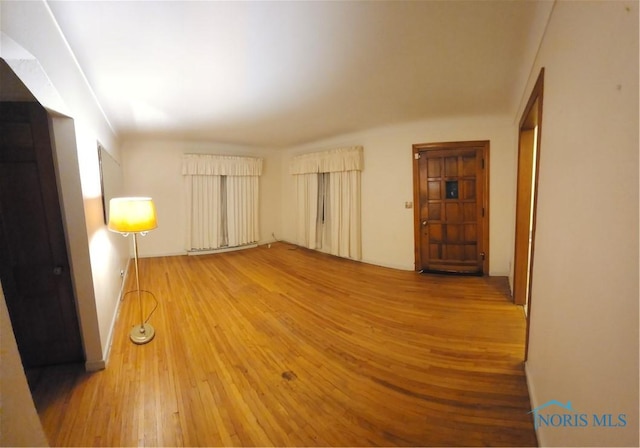 empty room with hardwood / wood-style flooring