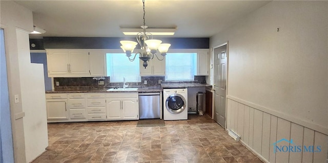 kitchen featuring stainless steel dishwasher, white cabinets, sink, and washer / clothes dryer