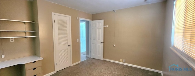 interior space featuring multiple windows and carpet floors