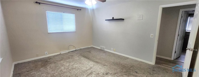 spare room featuring carpet and ceiling fan