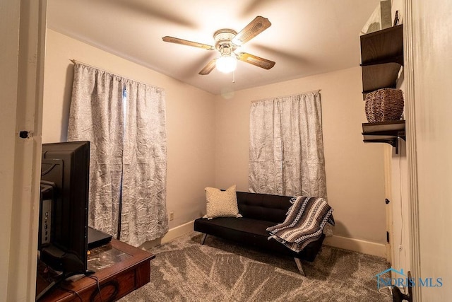 living area with ceiling fan and carpet floors