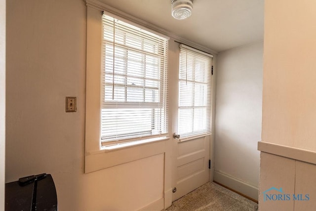 entryway featuring light colored carpet