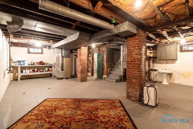 basement with sink and heating unit