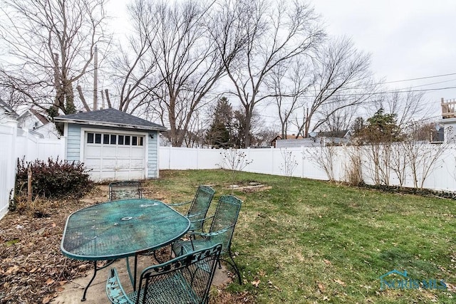 view of yard featuring a garage and an outdoor structure