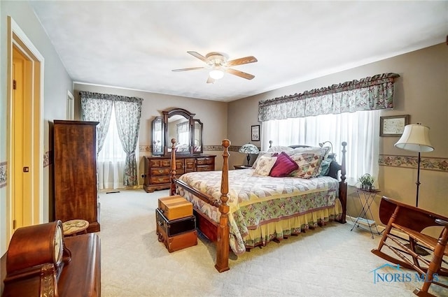 bedroom featuring light colored carpet and ceiling fan