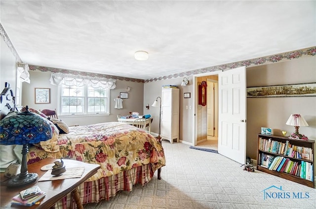 bedroom featuring light carpet