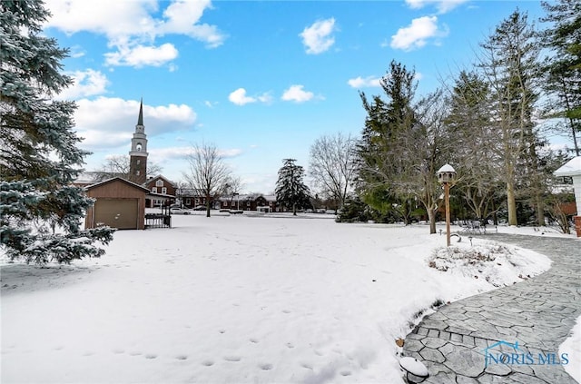 yard covered in snow with a garage