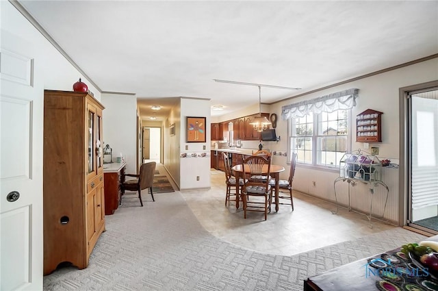 dining area featuring crown molding and an inviting chandelier