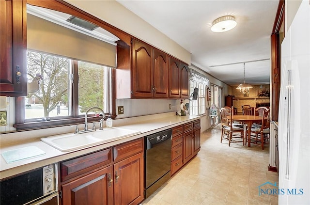 kitchen with dishwasher, pendant lighting, and sink