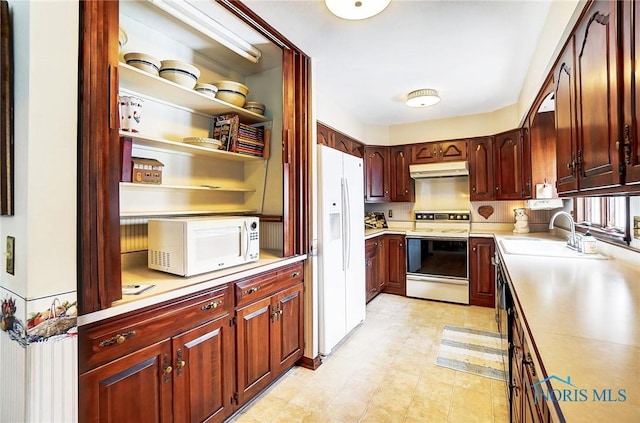 kitchen featuring white appliances and sink