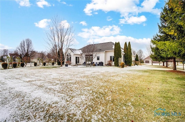 rear view of property featuring a yard