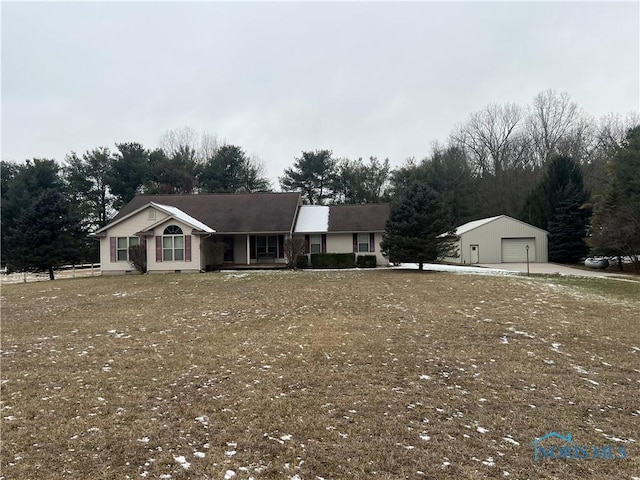 view of front of home featuring a garage and an outbuilding