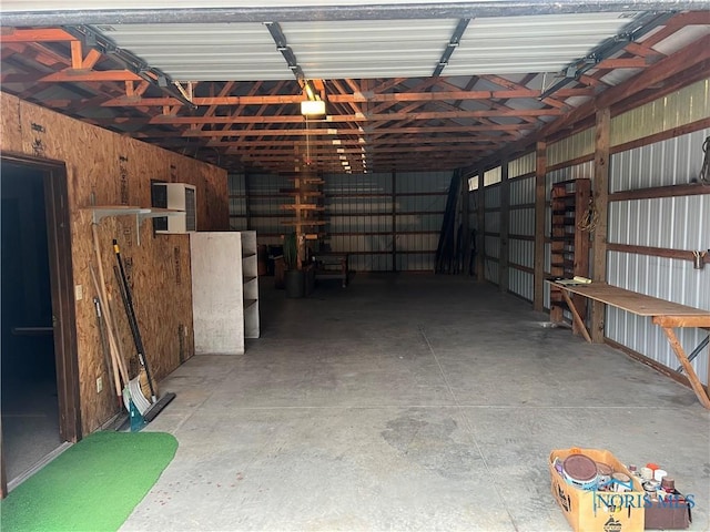 garage featuring wood walls and a garage door opener