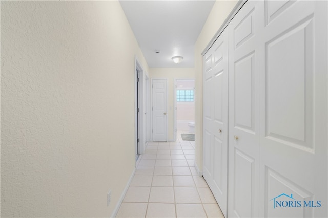 corridor with light tile patterned floors