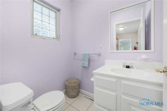 bathroom featuring toilet, tile patterned flooring, and vanity