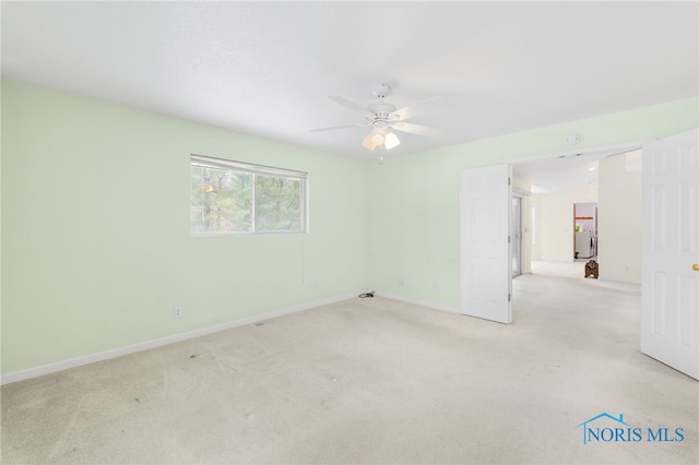 unfurnished room featuring light carpet and ceiling fan