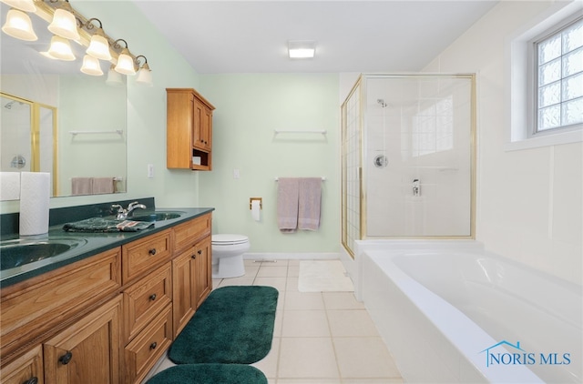 full bathroom with tile patterned flooring, plus walk in shower, vanity, and toilet