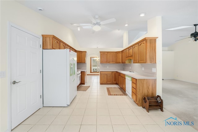 kitchen with white appliances, ceiling fan, light carpet, and sink