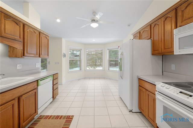 kitchen featuring white appliances, ceiling fan, sink, and light tile patterned floors