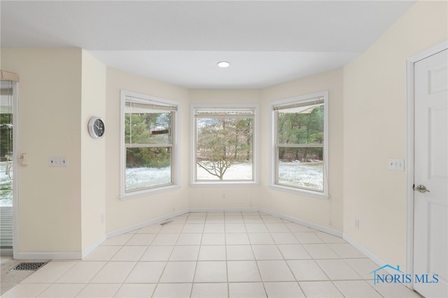 unfurnished dining area featuring light tile patterned flooring