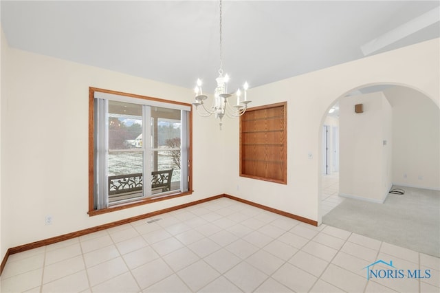 unfurnished dining area featuring light carpet and a chandelier